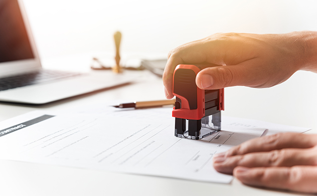 Lawyer working in office. Notary signs document