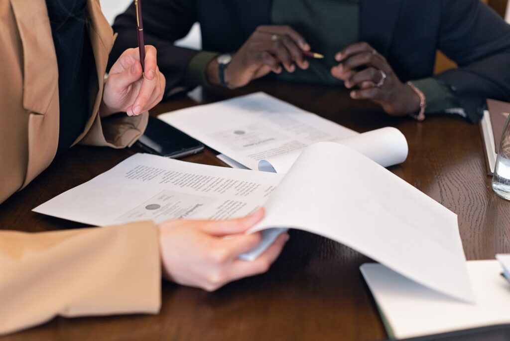 Professionnels examinant des documents administratifs de conformite Qualiopi lors dune reunion