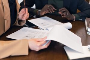 Professionnels examinant des documents administratifs de conformite Qualiopi lors dune reunion